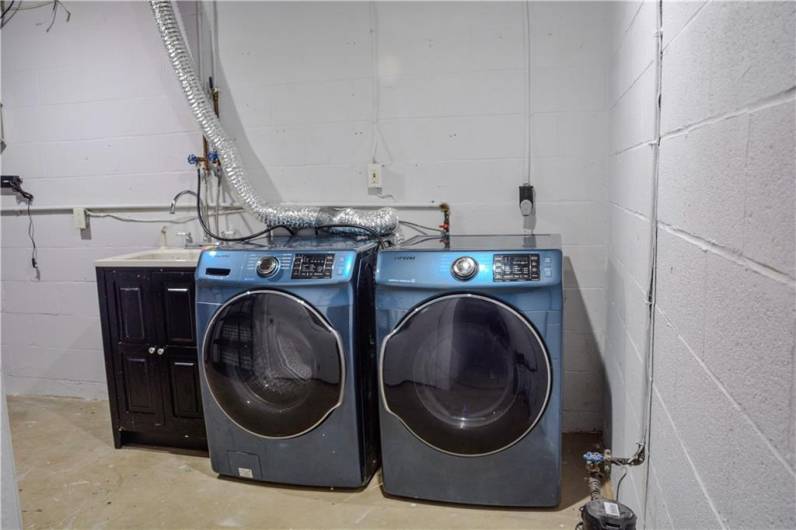 a Newer washer and dryer complete the laundry room.