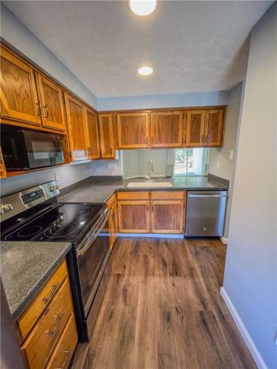 Bright kitchen with newer stainless appliances.