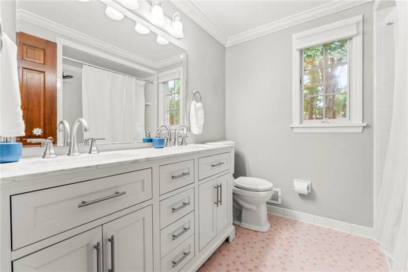 One of Two Full Baths on the Upper Level with New Countertops , Double Vanity, and Stainless Steel Delta Faucet Set.