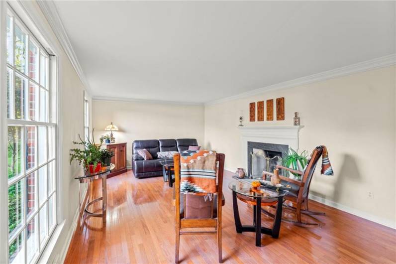 The Formal 20x13 Living Room Calls in the Natural Sunlight & Reflects off of the Original Hardwood and Bright Crown Molding Detail.