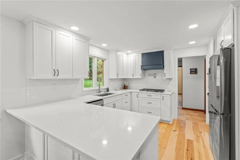 Gorgeous Quartz Counters Shine in the Modern Recessed Lighting.