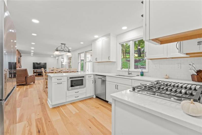 The Kitchen has New Engineered Hickory Hardwood Ran Throughout & Extends Under Cabinets & Appliances and Into the Den En-Suite Area.