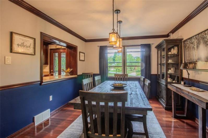 The Brazilian hardwood floors extend into the 13x11 dining room with crown molding and a serving area opened to the kitchen.