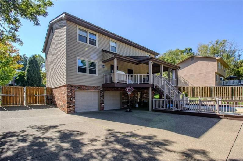 The 126 foot long exposed aggregate drieway wraps around the back for a perfect backyard to enjoy outside sporting activities and there is a 20x12 patio below the back deck for further entertaining. The gate to the left has remote controls and 2 touch keypads on both the front and rear side of the gate.