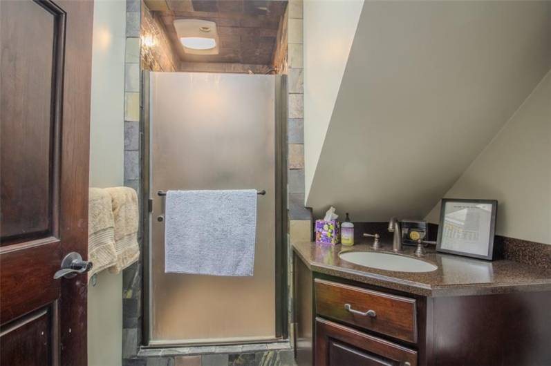 The game room has an adjacent 3rd full bath with an incredible shower stall.