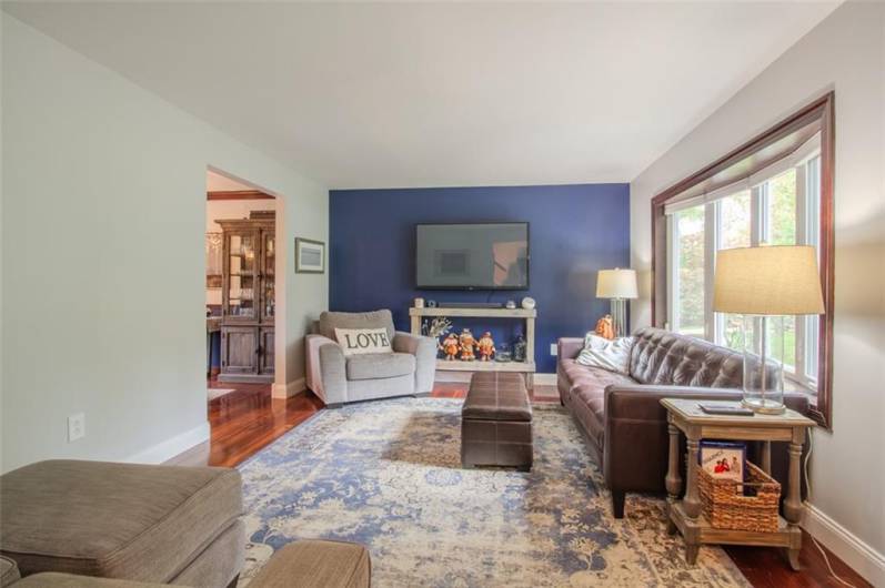 Spacious 18x12 living room with Brazilian hardwood floors and bow window.