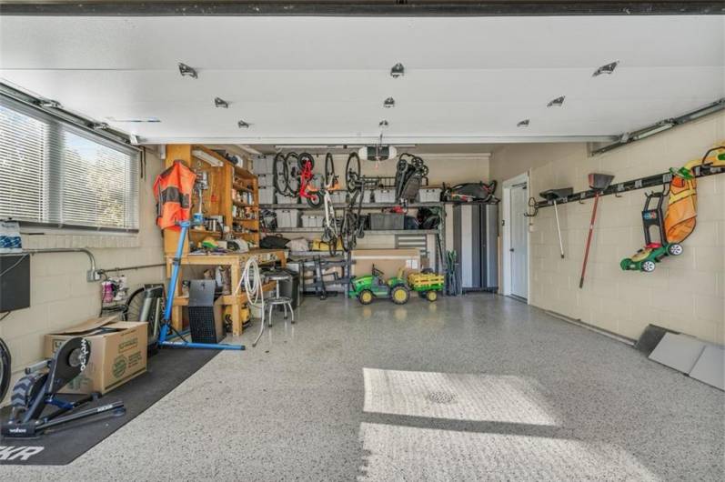 Check out this over-sized 2-car garage with Gladiator brand garage shelving, staying with the home, a custom work bench and the industrial grade epoxy garage floor.  So much space for your belongings! This is Your Home!