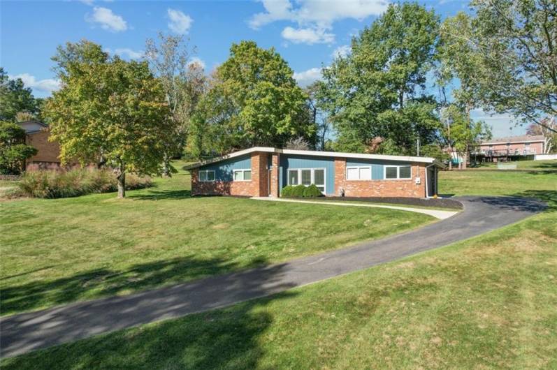 Another front view of this classic ranch home with the new resurfaced driveway, completed in 2024 by Todd's Asphalt. This home is picturesque!