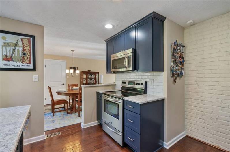 Lovely, updated kitchen with gleaming engineered hardwood flooring and state-of-the-art stainless-steel appliances.