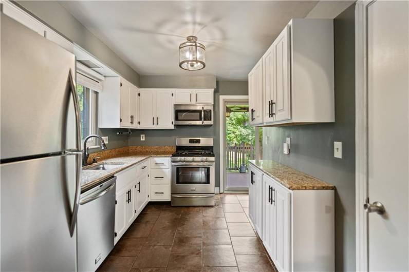 Kitchen with SS Appliances and Granite Countertops.