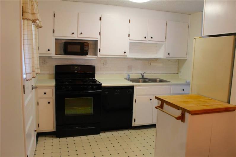 Kitchen with access to the back screened in sunporch