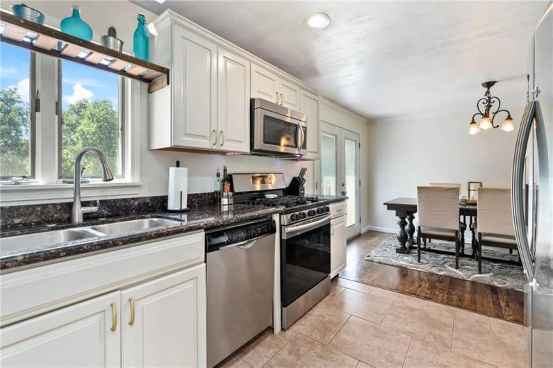 Light and bright kitchen with window over double bowl sink, pull down faucet and disposal.