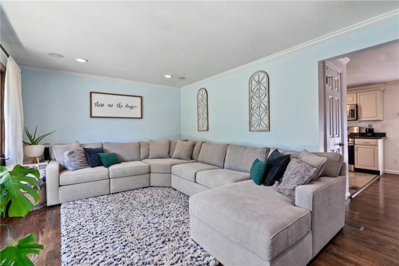 Gleaming refinished hardwood flooring in living and dining room and hallway.