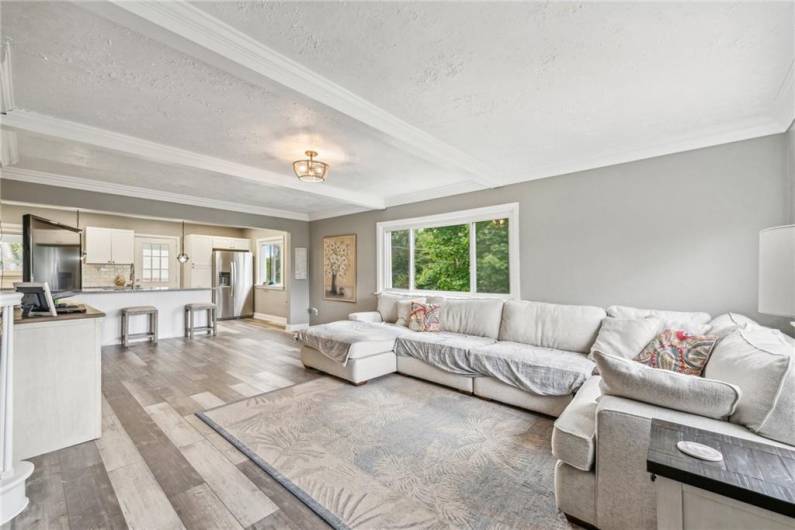 Living room with space for dining that flows into the kitchen