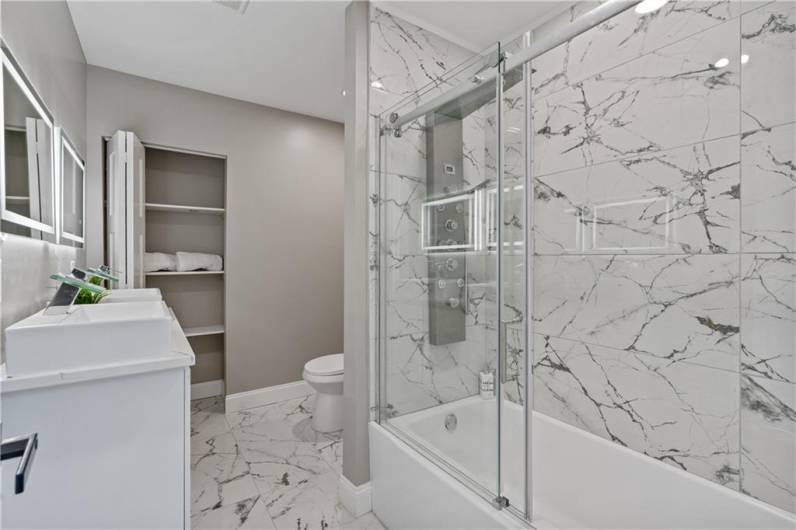 Spacious bathroom with marble finishes and ample storage