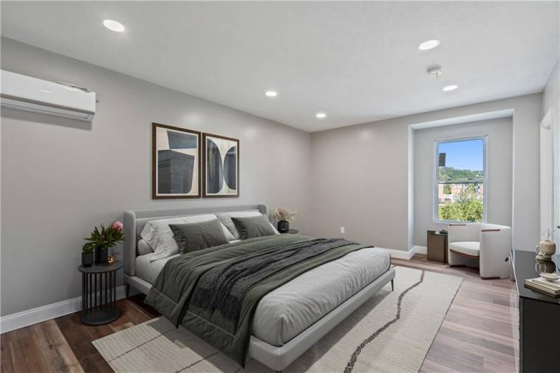 Spacious bedroom with recessed lighting and ample storage space.