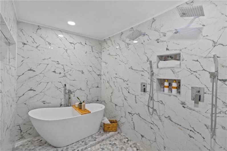 Spacious bathroom with elegant marble finishes and modern fixtures.