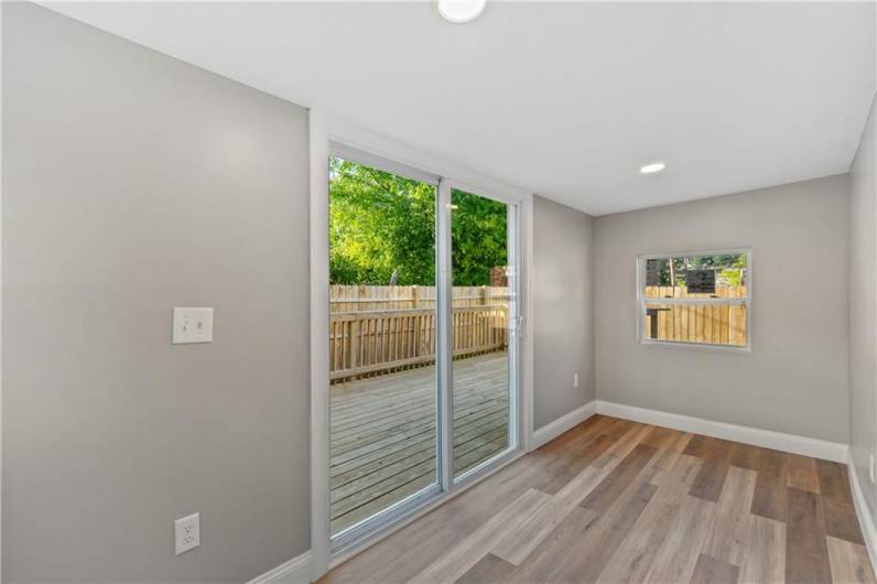 A versatile sunroom offers a bonus sitting area, man cave or her room that leads to the large back patio.