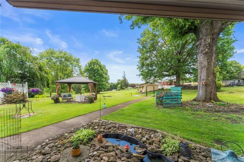 Expansive Flat Backyard perfect for Outdoor Gatherings, Gardening, Playing & Enjoying the Beauty of Nature