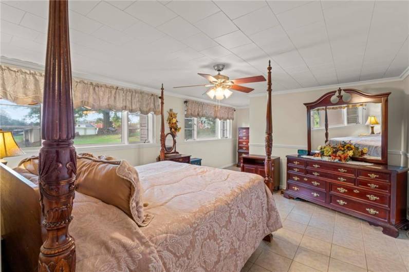 Massive 16x14 Lower-Level Bedroom w/ hallway to Enormous 8x8 Walk-in Closet, Wall of Windows, Ceiling Fan Light & Ceramic Tile Floors