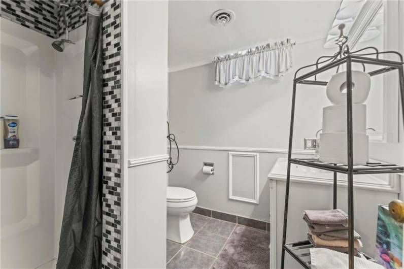 Beautifully Updated Full Bathroom in Lower-Level w/ Ceramic Tile Floors & Shower Stall accented by Mosaic Tile