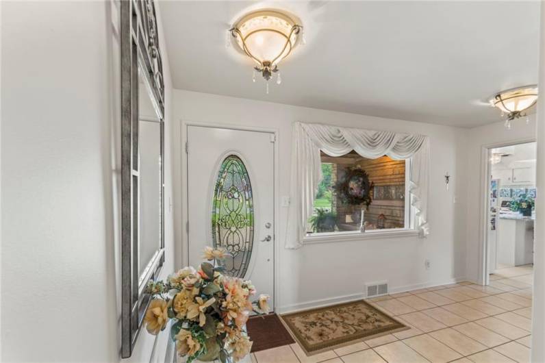 Spacious & Bright 14x7 Front Entry Accented by Oval Lead Glass Door, 2 Gorgeous Antique Style Light Fixtures, Ceramic Tile Floor and Big Double Coat Closet!