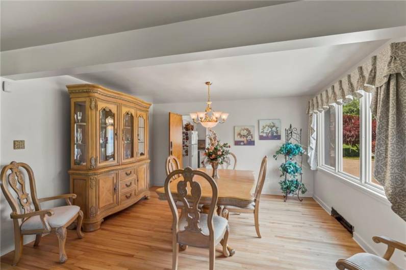 Formal Dining Room just off Eat-in Kitchen offering a Wood Saloon-Style Swing Door to Kitchen Quality Plaster Walls & Original Refinished Hardwood floors