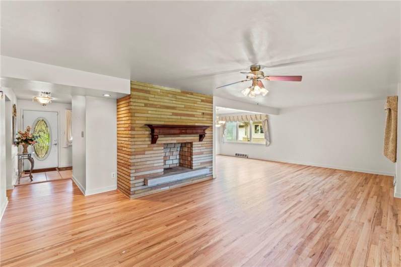 Large 29x16 Living Room w/ Gorgeous Refinished Hardwood Floors, Stone Fireplace, Ceiling Fan Light & Plaster Walls