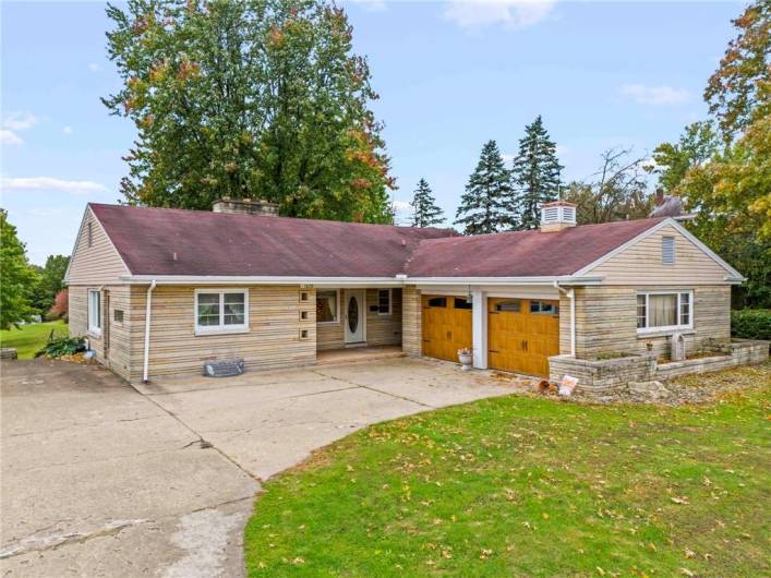 OVERSIZED 2 Car Attached Garage boasting Stylish Updated Garage Doors each Enhanced w/ Double Ornate Windows PLUS plenty of extra Off-Street Parking in front and an additional space on side next to Kitchen Door (easy Grocery drop off!)