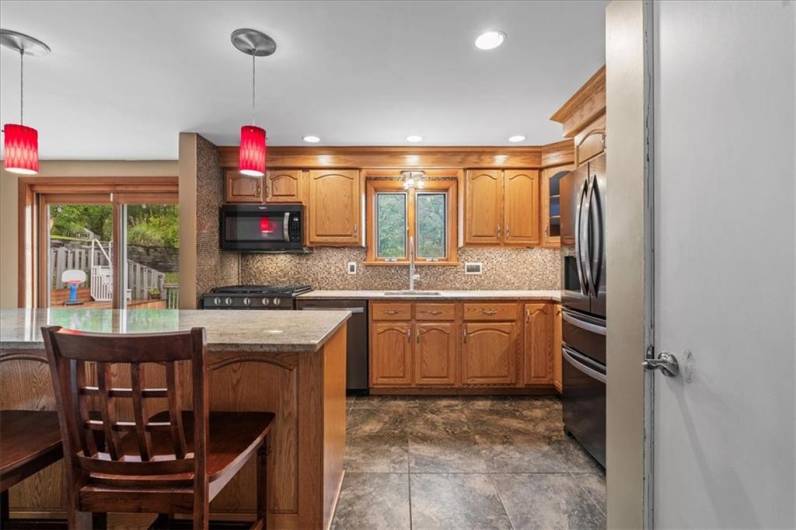 Granite custom kitchen with newer appliances and large island