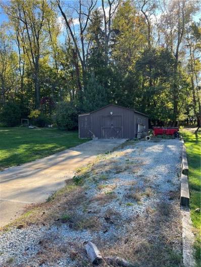 Large shed with outside storage also for easy to access tools and wheel barrels plus graveled area to park bigger vehicles.