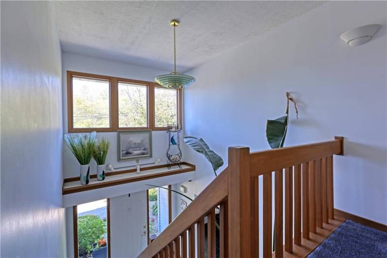 A row of windows and a ledge in the entryway provide an opportunity for more natural light and a place to decorate.