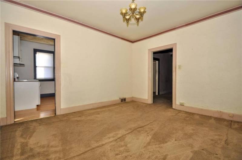 The dining room with access to the kitchen to the left and living room to the right