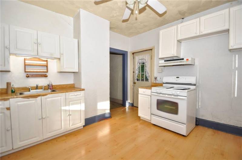 The spacious kitchen showing access to the back deck and to the dining room