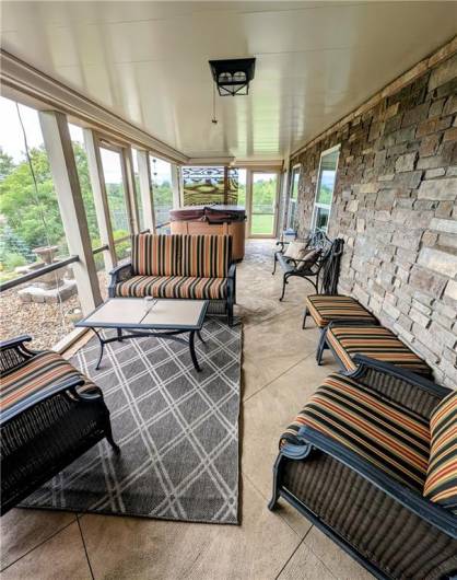 Screened in lower patio with hot tub