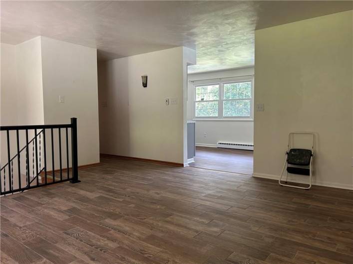 Huge spacious living room, doorway to kitchen.