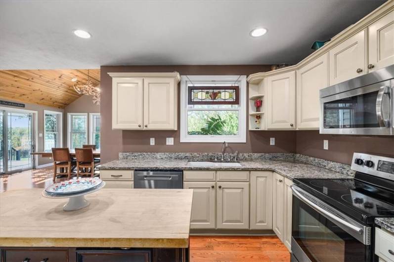 Plenty of storage in the creme wood cabinets and center island.