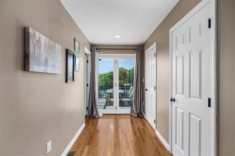 The primary bedroom has one walk in closet and an additional closet. French doors out to the deck.