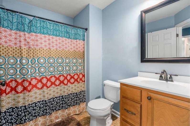 Ensuite bath in second bedroom on upper level.