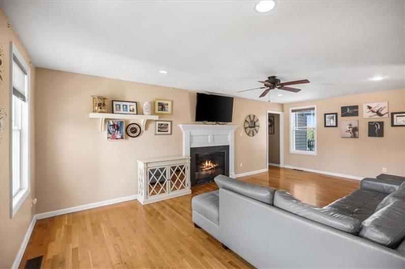 Large living room off the entry with cozy fireplace