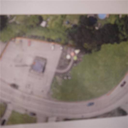 VIEW OF PROPERTY WHICH INCLUDES VACANT LOT AND DEVLOPED SECTION WITH COMMERCIAL BUILDING  AND PARKING LOT