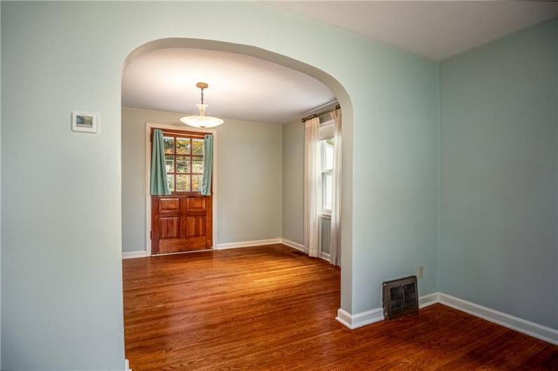 Living Room to Dining Room view.  Hardwood floors, beautiful wood door