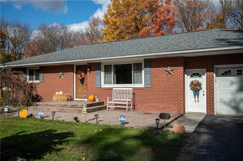 Stamped concrete patio adorns the front of the home!