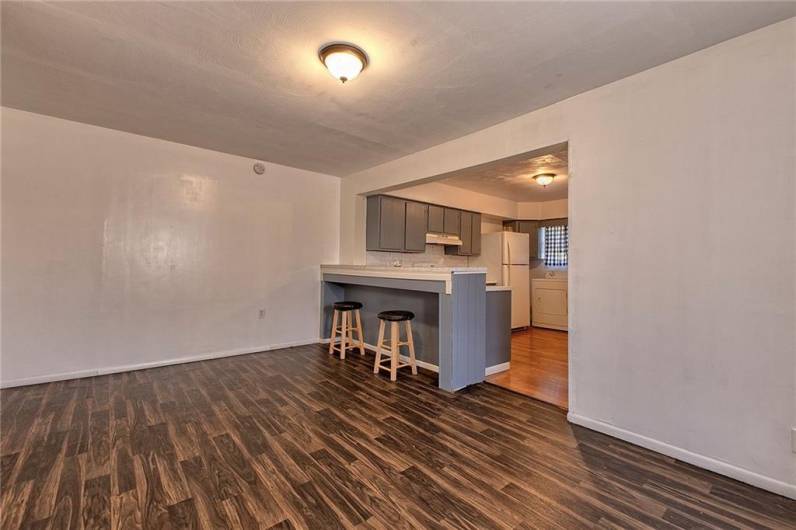 The dining room of 116 has newer luxury vinyl tile flooring.