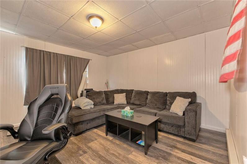 The living room has luxury vinyl plank flooring and is spacious.