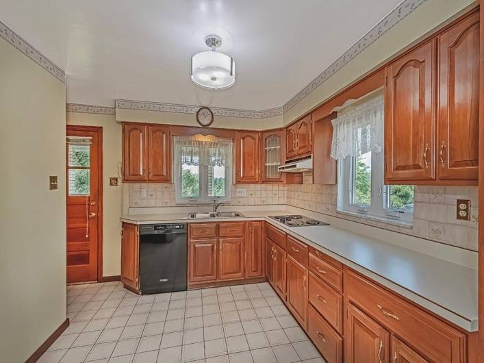 Eat in kitchen with beautiful Chery Cabinets. Back door leads to a covered back porch.