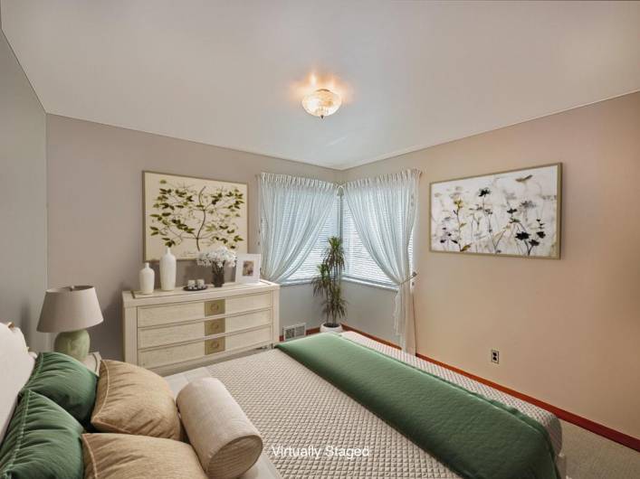 Primary bedroom is in the front of the home with cute corner windows to showcase the lovely yard.