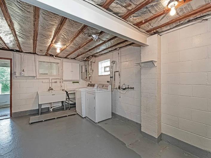 View of laundry area, washer & dryer stay. The door to the left has a mud room before you go outside, which is perfect for extra storage.