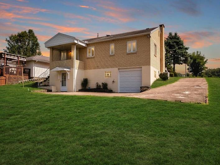 Evening view of home! Imagine your personal touch on this home and yard!