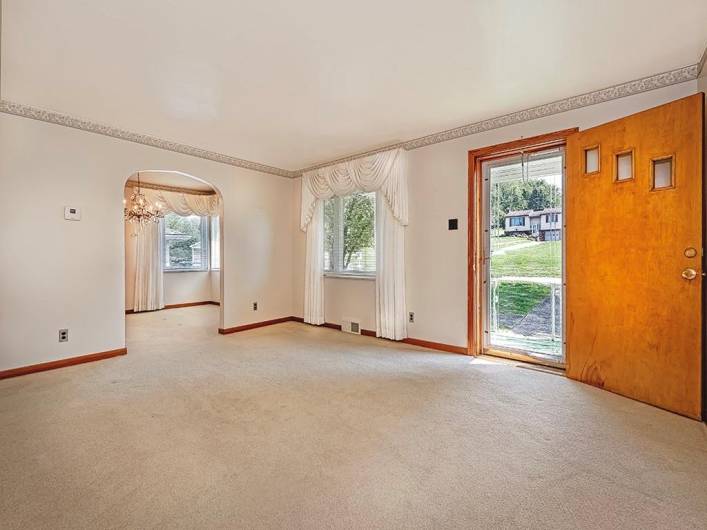 Another view of the living room. Hardwood floors are under all the carpeting in the home.